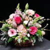 This elegant grapevine basket is brimming with the prettiest pink cut flowers.
