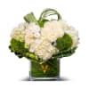 This elegant bouquet features white hydrangeas, white roses, and greens, creating a