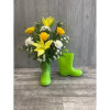 Children&#039;s size rain boots filled with fresh flowers. Colors may vary. 