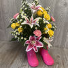 Children&#039;s size rain boots filled with fresh flowers. Colors may vary. 