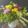 Bright and cheery bouquet in a sweet little vessel, sure to brighten