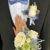 Elegant white roses with blue delphiniums and mixed greens. This is a
