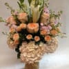 This arrangement comes in shades of light pink and white, complete with