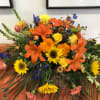 Casket Spray With roses and sunflowers 
Brighten any room with these fall
