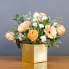 Peach Roses, Gerbera Daises and white Carnations displayed in a gold box.