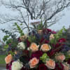 Romantic blossoms and colors gathered in a glamorous container to celebrate love.