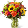 Stunning sunflowers are masterfully woven together with other brightly hued blooms to