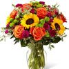 Stunning sunflowers are masterfully woven together with other brightly hued blooms to