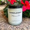 A handcrafted scented soy blend candle at our store. The candle is