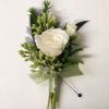 Handmade Boutonn&iacute;ere typically using a spray rose and greenery,
Customizable upon request, availability