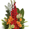 This artistically arranged bouquet of orange roses and lilies and other brightly