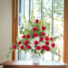 Red and white premium blooms of flowers combine with lush foliage in