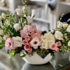 The Savannah Arrangement is filed with light pink roses, spray roses, lisianthus