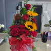 Filled with multiple roses your choice of color with 2 sunflowers with