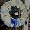 22 inch round wreath with roses, hydrangea, mums and lilies. Can be