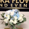 Beautiful white floral arrangement with that touch of blue for that loved