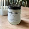 A handcrafted scented soy blend candle at our store. The candle is