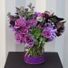 This unique floral design has imported lavender roses, succulents, and mixed flowers