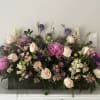  A harmonious arrangement of garden roses, delicate lisianthus, soft caspia, lush