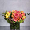 An impressive arrangement featuring a generously filled glass vase featuring mixed roses