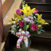 A beautiful bouquet of Pink Roses and Yellow Lilies with a touch