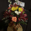 A mix of Fall colored flowers accenting Red Lilies 