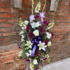 A full easel arrangement consisting of a variety of Purples and Whites