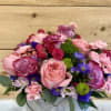 Beautiful pink and purple roses with a mixture of other flowers 