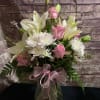 An elegant arrangement of white Lillies with pink roses arranged in a