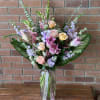 Tall and showy beautiful bouquet with pink lilies, lavender stock, roses, exotic