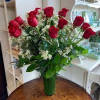 An impressive presentation of two dozen fragrant, long-stemmed red roses accented with