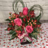 Pink and red bouquet arranged in a cube 