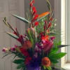 An array of exotic flowers arranged in a vase. 