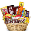 A variety of chocolate and candy arranged in a basket 