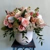 A beautiful arrangement featuring soft tones of pink, white, and other delicate