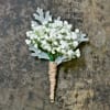 Select this country boutonniere of babies breath and dusty miller with a
