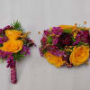 Select this colorful boutonniere and wristlet corsage set featuring ranunculus, spray roses