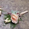 Select this boutonniere with pale spray roses with a ivory stem wrap.
ALL