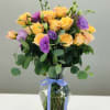2 dozen peach roses with interspersed purple lisianthus. Playful colors experiencing life