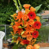 orange standing spray with roses, Gerber daisies, lilies and gladiolus 