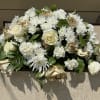 Gold and white casket spray with roses and mixed flowers.  (All