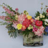 A lush spring arrangement of hydrangeas, peonies, roses, spray roses, calla lilies