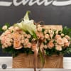 A lovely basket arrangement adorned with the delicate charm of pink spray