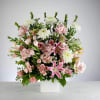 This pink and white basket arrangement is a lovely sendoff and tribute.
