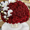 Gorgeous red roses in a hat box with orchids . We can