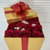 Tall golden gift box filled with 16 fresh red roses.