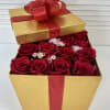 Tall golden gift box filled with 16 fresh red roses.
