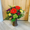 A selection of bright and cheerful flowers arranged in a vase or
