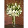 Bunches of Casablanca Lilies in a clear glass vase have the dimensions