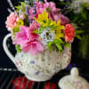 Enjoy a beautiful tea pot filled with flowers! 